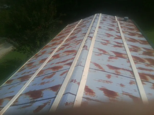 Rusted metal roof panels with new wood purlins before replacement — Storm Damage Roof Repair in Ocean Springs by Roofing Brothers