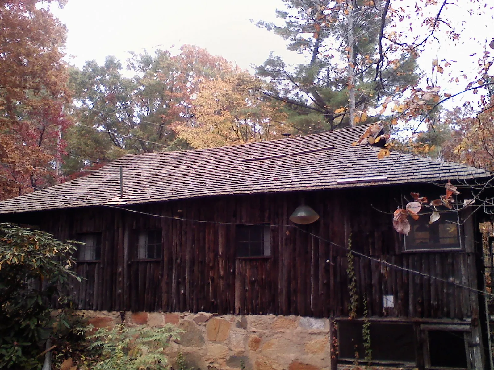 Weathered wood shake roof on a rustic board sided cabin in Ocean Springs